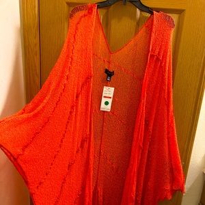 Woman’s coral one of a kind cover up.